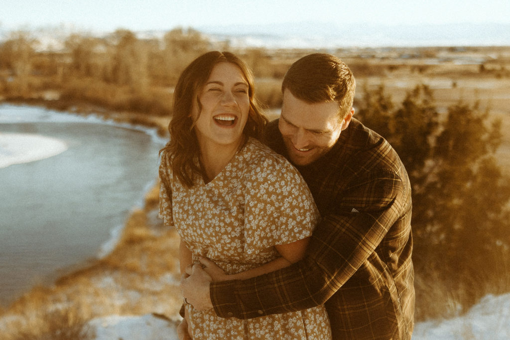 Couple posing for winter maternity photos in Montana