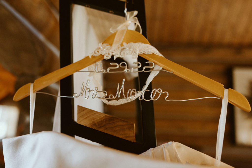 wedding dress with custom hanger name that says mrs mercer with wedding date