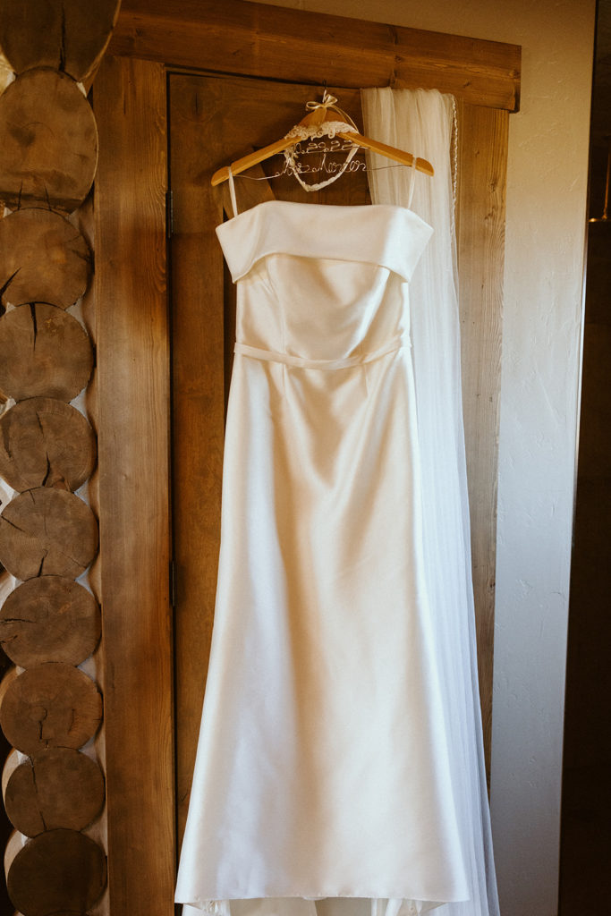 White simple wedding dress hanging