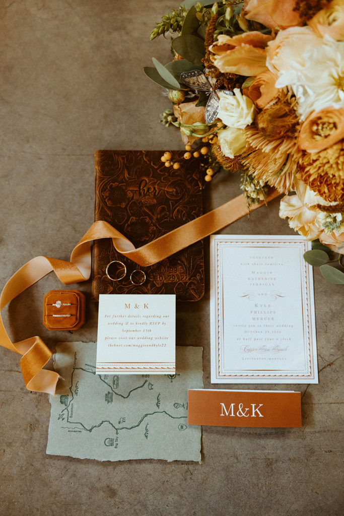 wedding details photo with flowers, rings, invites and a map for montana paradise valley wedding