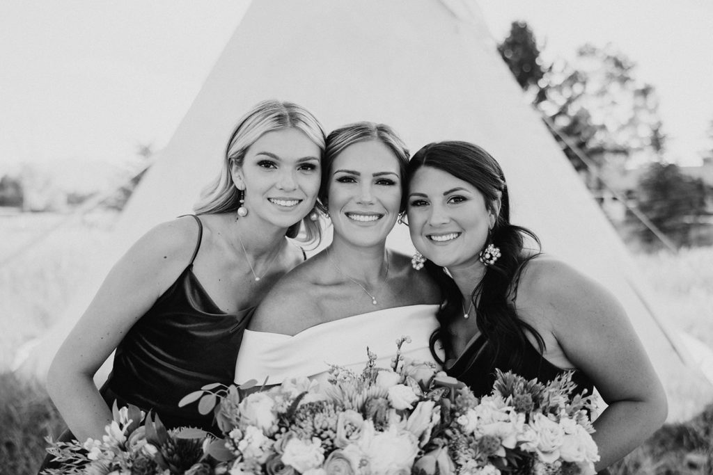 bride and bridesmaids posing for wedding photos