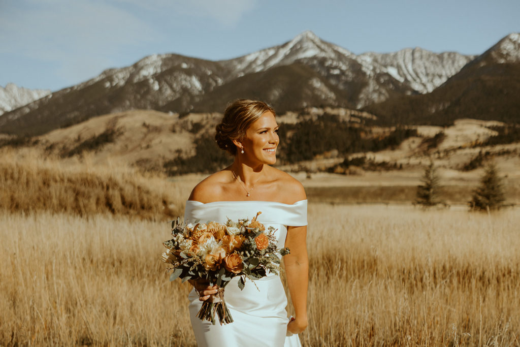 bride posing in front of montana mountains