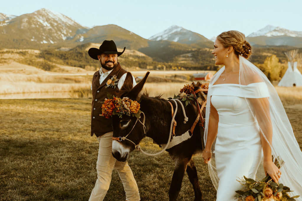 Bride and groom posing with donkey for Montana Paradise Valley wedding photos
