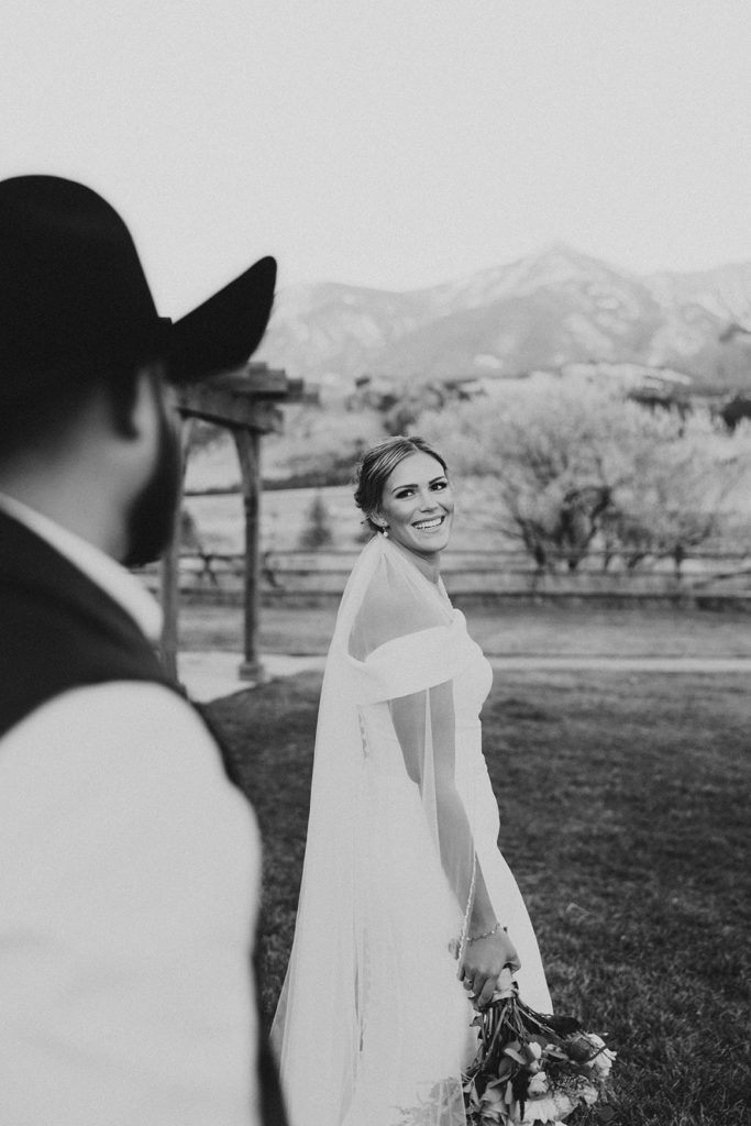 bride looking back at groom for montana paradise valley wedding photos