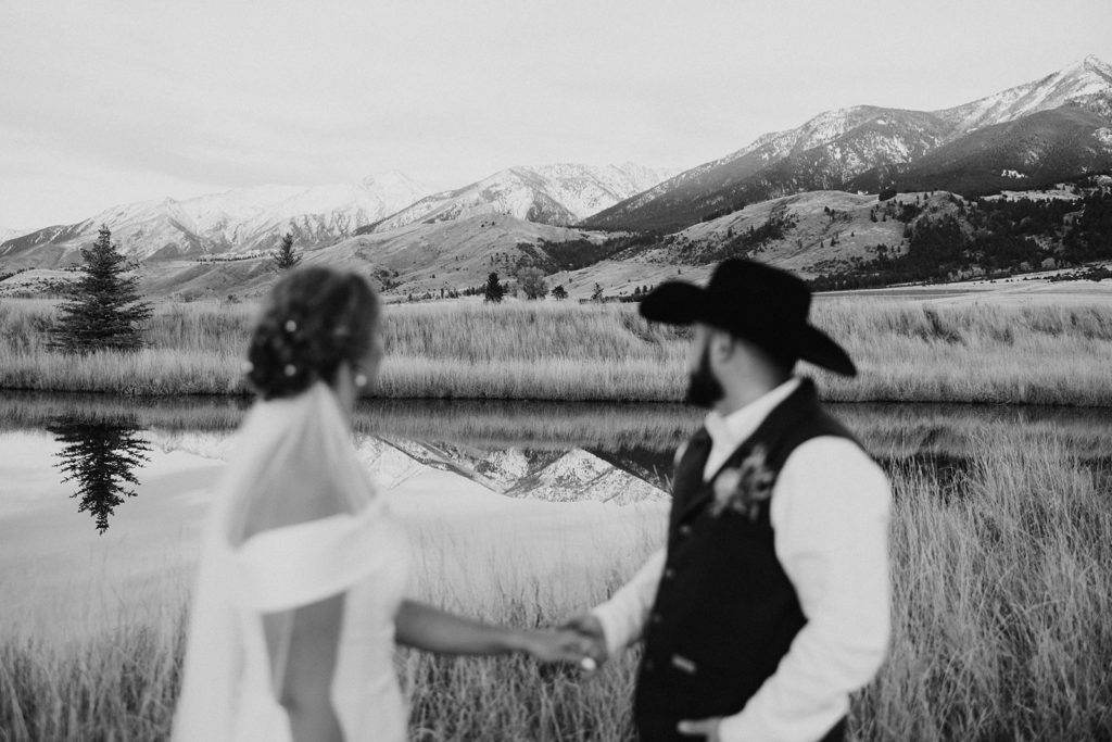 bride and groom looking at montana mountains during wedding photos