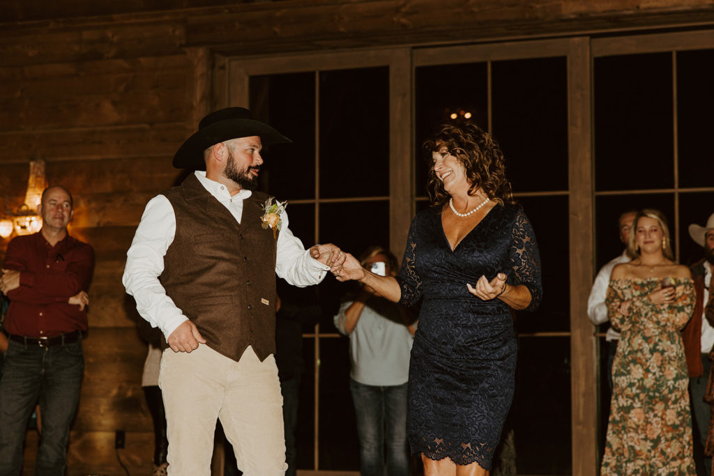 groom dancing with mother at wedding reception