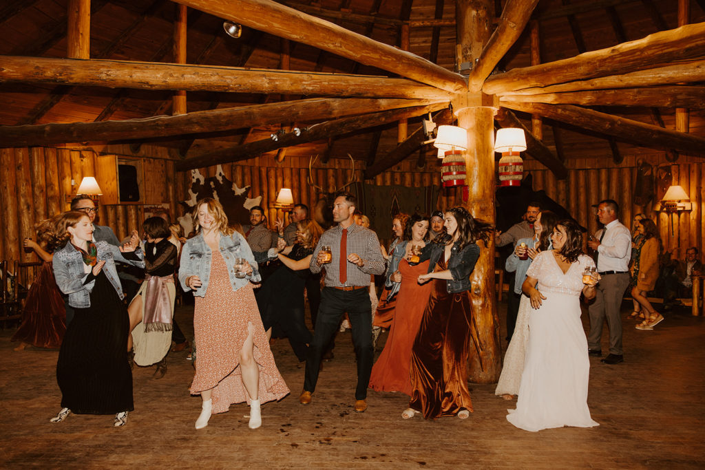 Wedding guests dancing at western wedding reception 