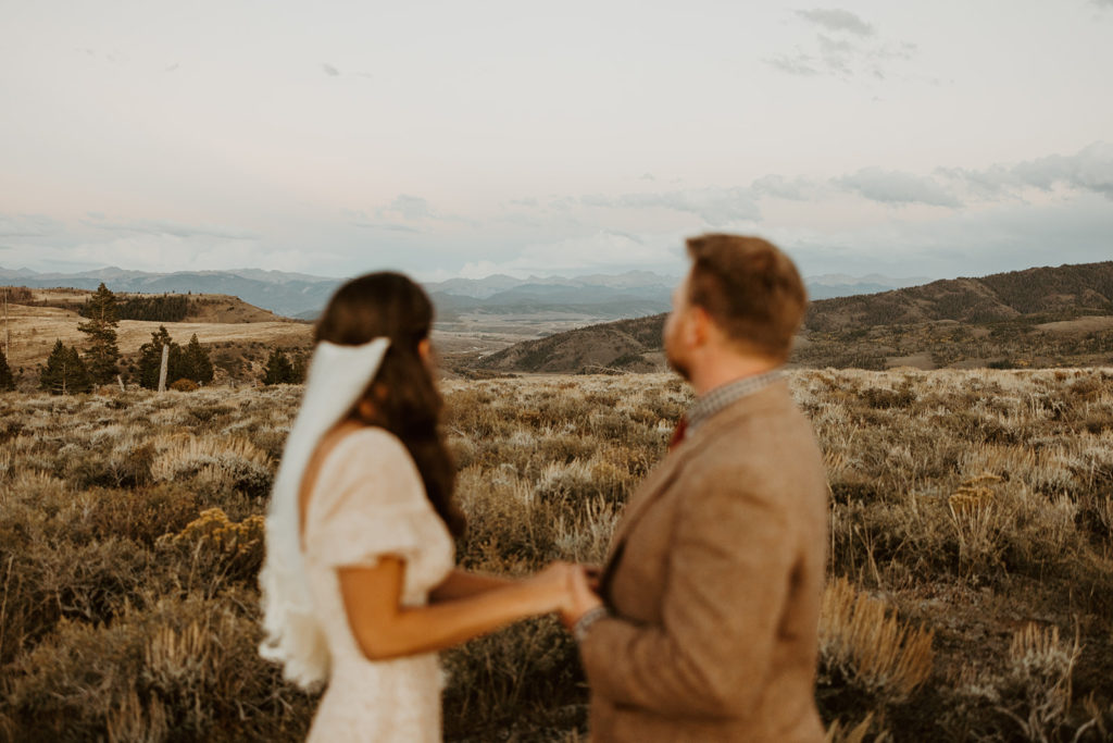 Bride and groom posing for wedding portraits on a ranch in Colorado